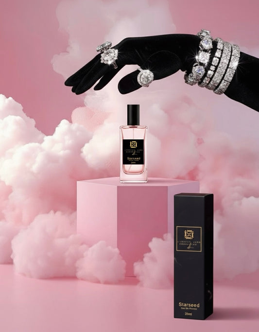 Perfume bottle and packaging with decorative hand holding jewelry against a pink cloud background