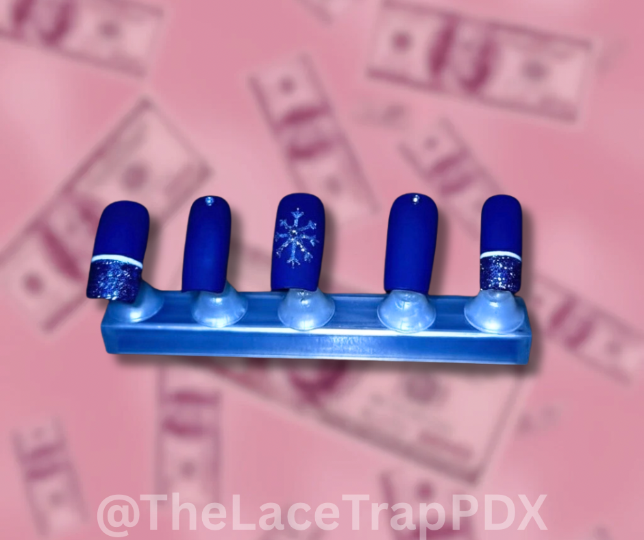 Blue  winter design press on nails  with snowflake design on a pink money background the lace trap