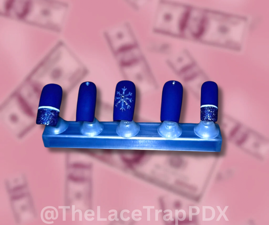 Blue  winter design press on nails  with snowflake design on a pink money background the lace trap